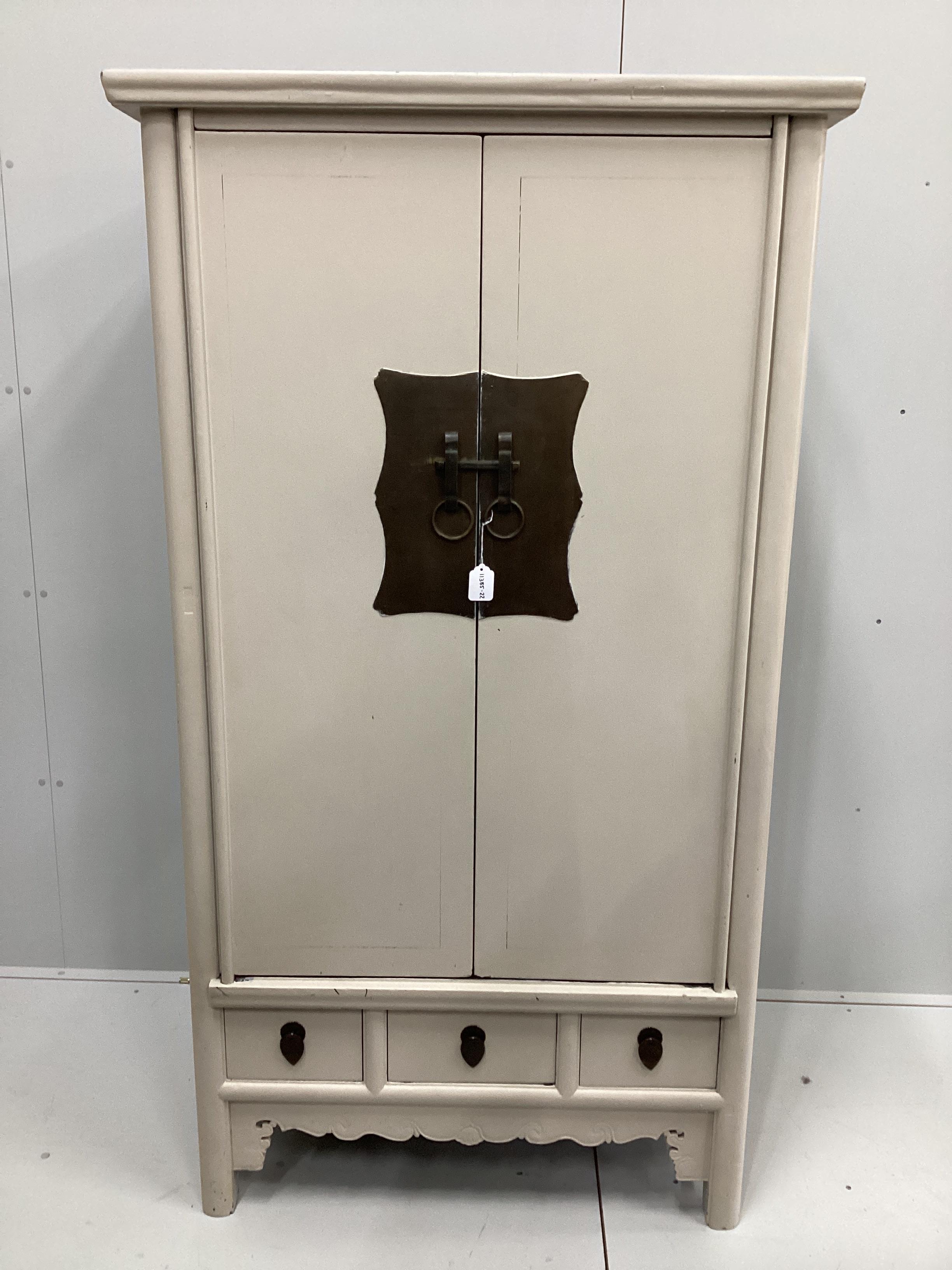 A Chinese elm two door side cabinet, later painted, width 99cm, depth 64cm, height 180cm